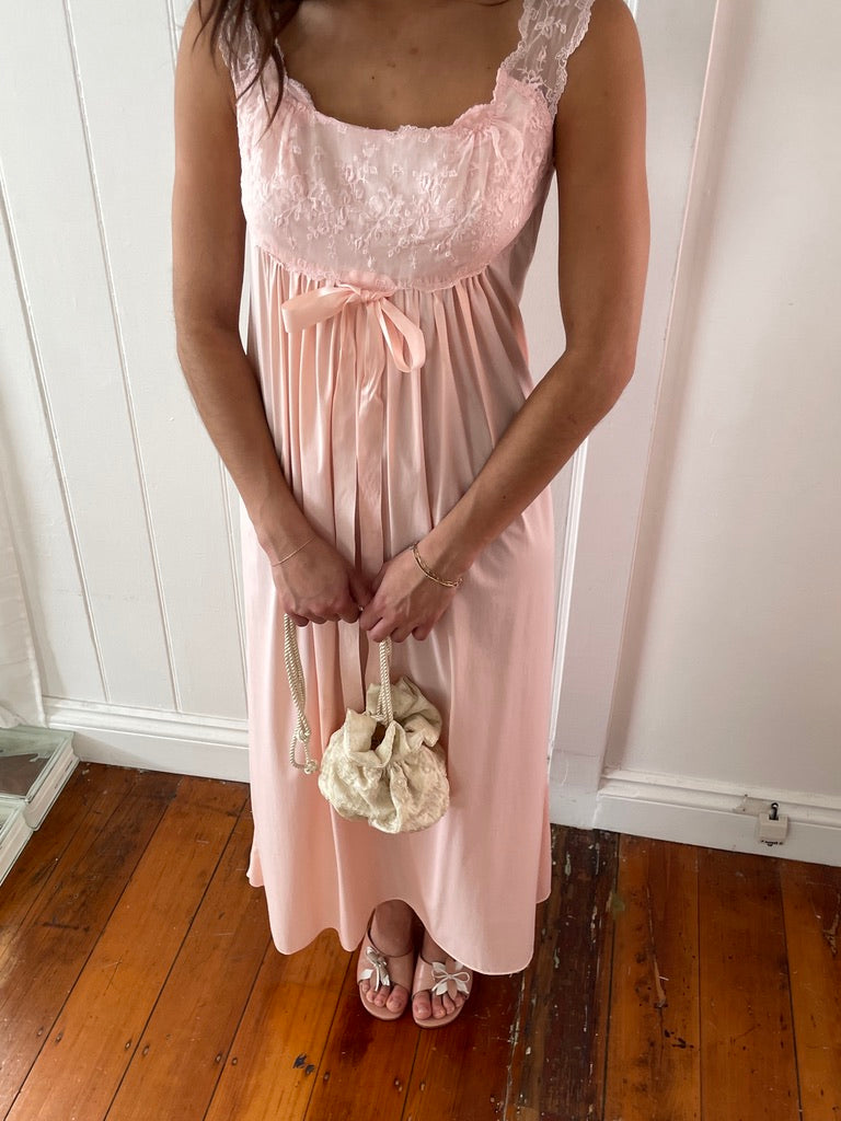 Vintage 1960s Vanity Fair pink slip dress with lace trim and bow